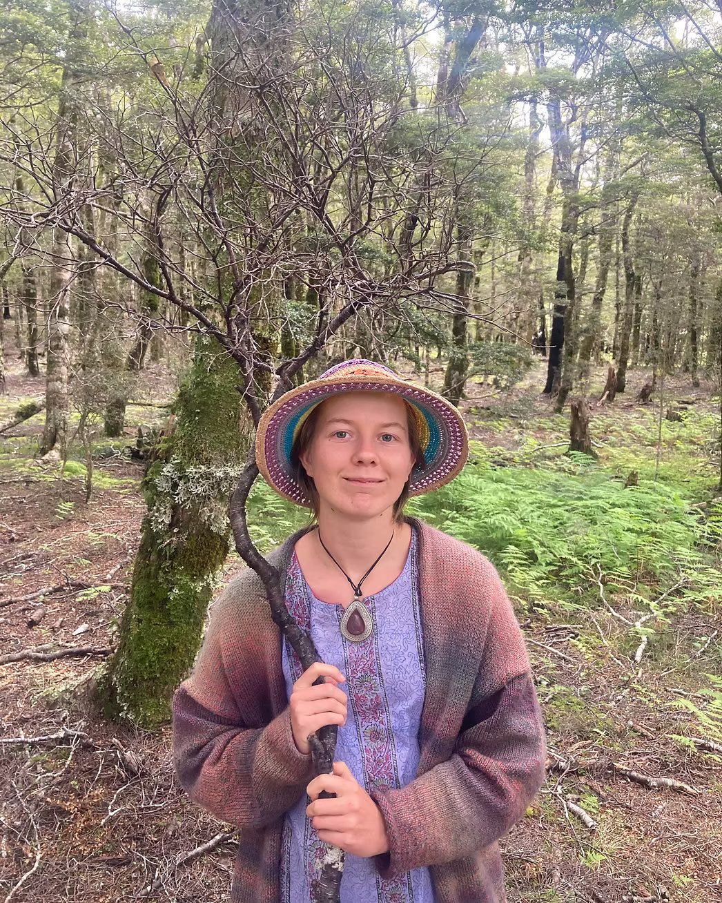 Mia Ruby Harrison in a forest wearing a colourful sunhat